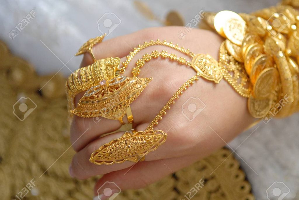 Gold jewelry on the hands of a Muslim bride. Hand of a bride in