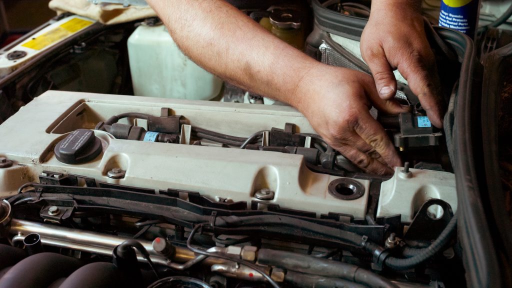 Mechanic working on car engine